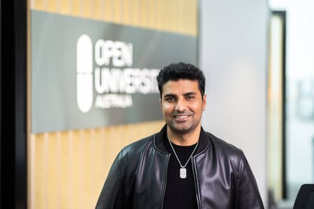 Open Universities Australia student advisor, Mohammad, standing in the office.