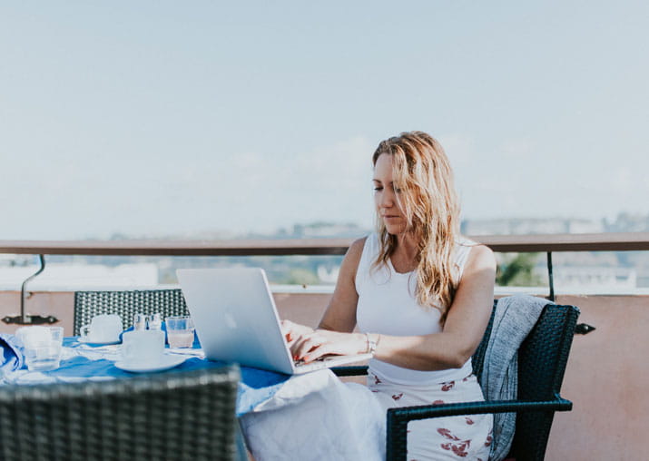 Woman on laptop outdoors