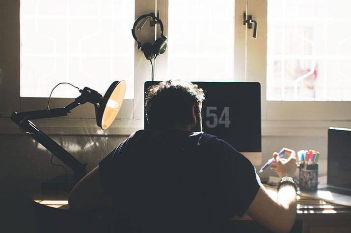 Man at desk studying for exams