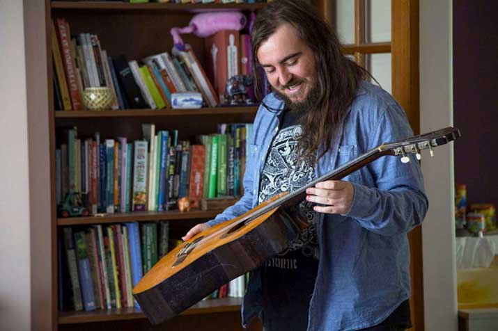 information technology student angus shaw holding instrument