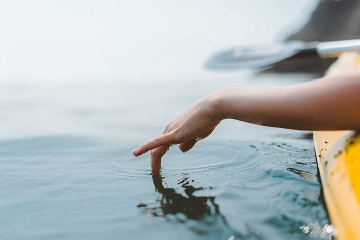 female-hand-in-the-water