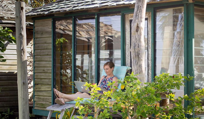 arts internet communication student laura maya frot studying on porch