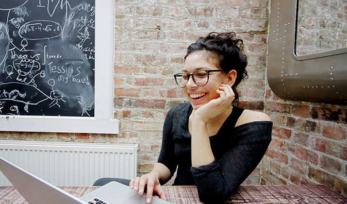 female-happy-working-on-laptop