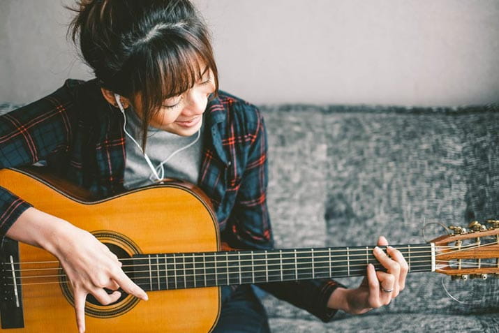 female-playing-the-guitar