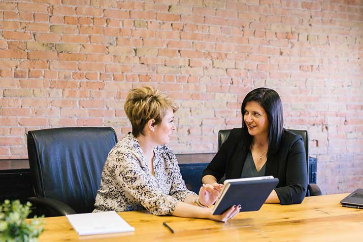 female-holding-tablet-in-meeting