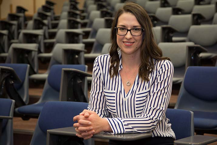 Lecturer Elise Sargeant sitting in a lecture hall
