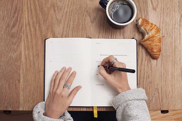 female writing in notebook