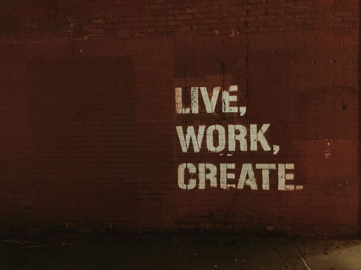 Live Work Create on red brick wall