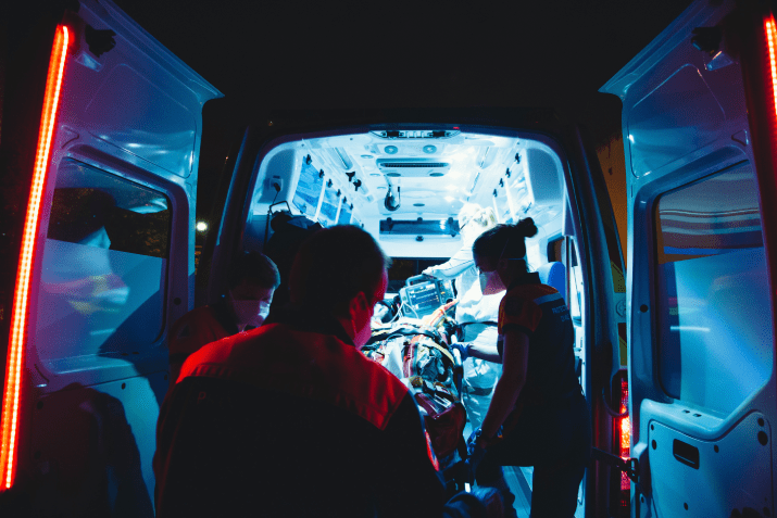 Paramedics loading a patient into an ambulance