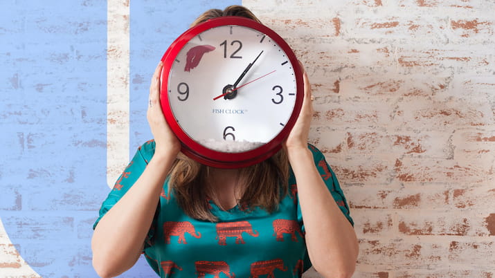 Person with clock covering their face OUA logo