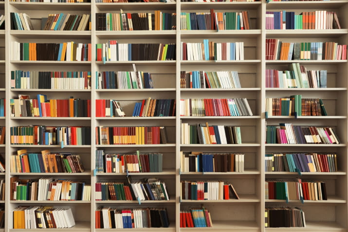 A large bookcase of colourful books