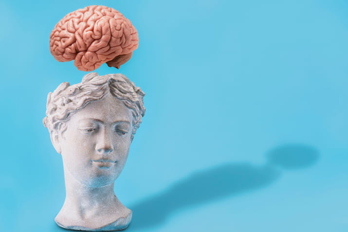 A brain floating above a classical statue bust