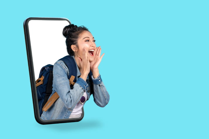 A young woman popping out of a giant phone and shouting into her cupped hands