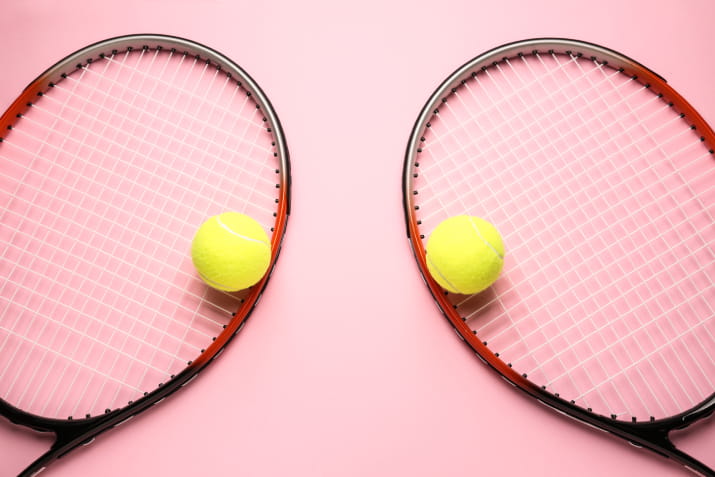 Two tennis rackets on a pink background