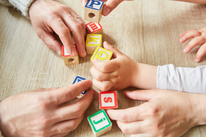 Hands playing with building blocks as part of therapy