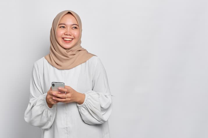 Young woman with smartphone in hijab