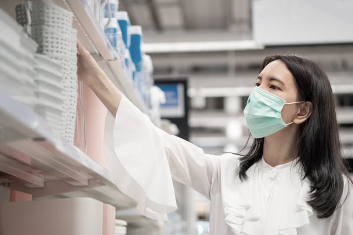 Woman with face mask and white coat