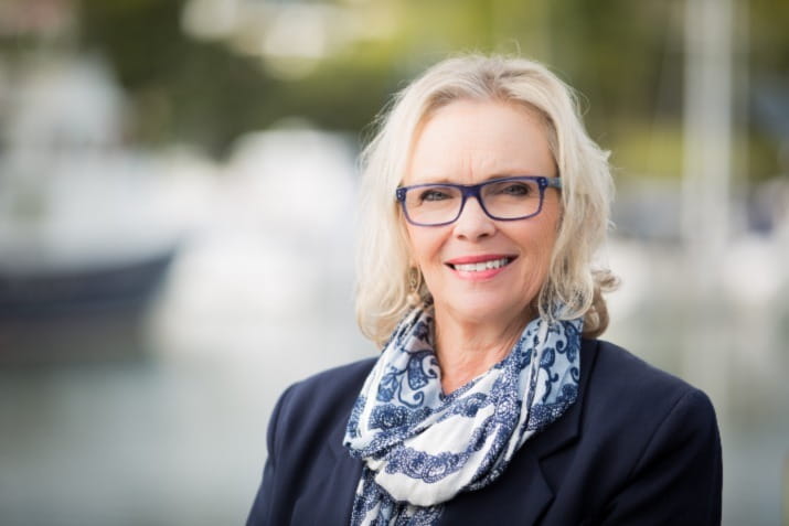 Middle aged business woman with glasses smiling