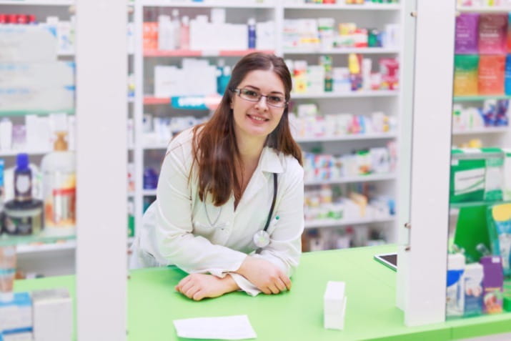 Female pharmacist at front desk