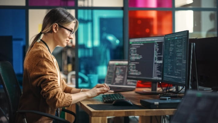 Female software developer sitting at computer