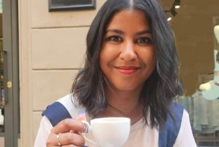 Rushani Epa smiling and holding a cup of tea