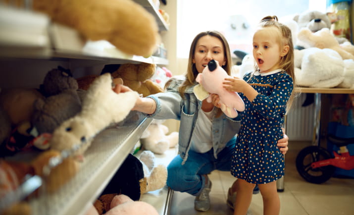 A woman and a young girl in a toy store