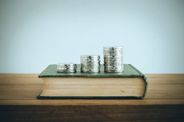 Coins stacked on books