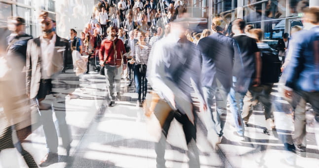 A blur of people walking in a public space