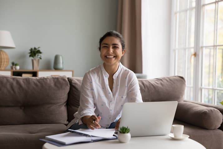 A smiling woman at a laptop