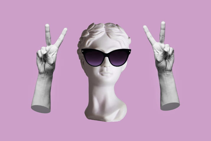 A statue wearing sunglasses and making the peace sign