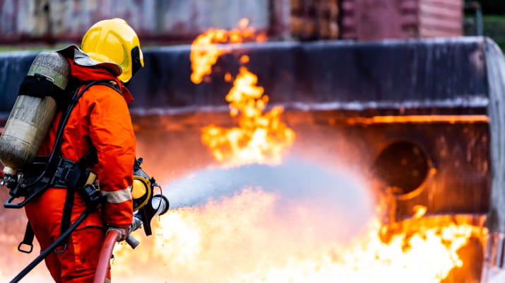 A firefighter hard at work putting out a chemical fire