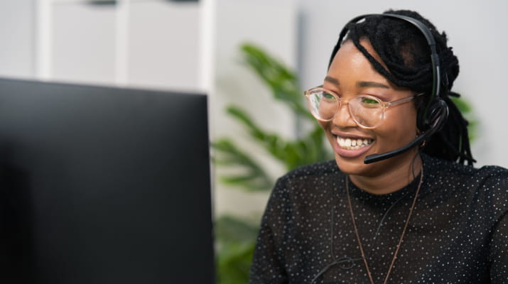 A smiling young IT help desk worker who headed straight into the workforce after earning her undergraduate certificate