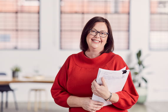 Woman in red holding paperwork