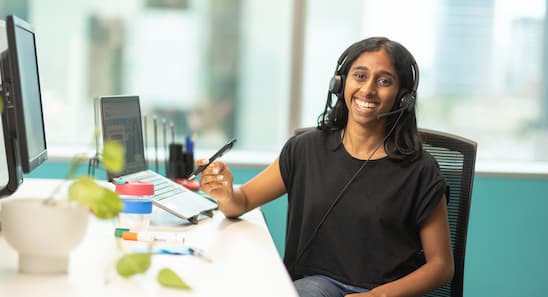 Open Universities Australia student advisor, Giselle, seated at a workstation.