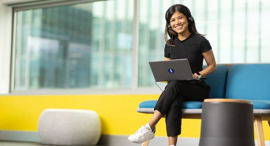 Open Universities Australia student advisor, Natcha, seated in the office.