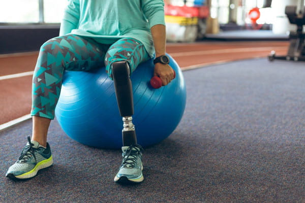 Female with a disability on a swiss ball in physical therapy