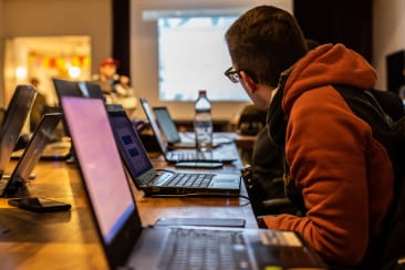 student attending class with laptop