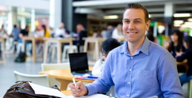 Open Universities Australia student David wearing professional clothes in a business setting.