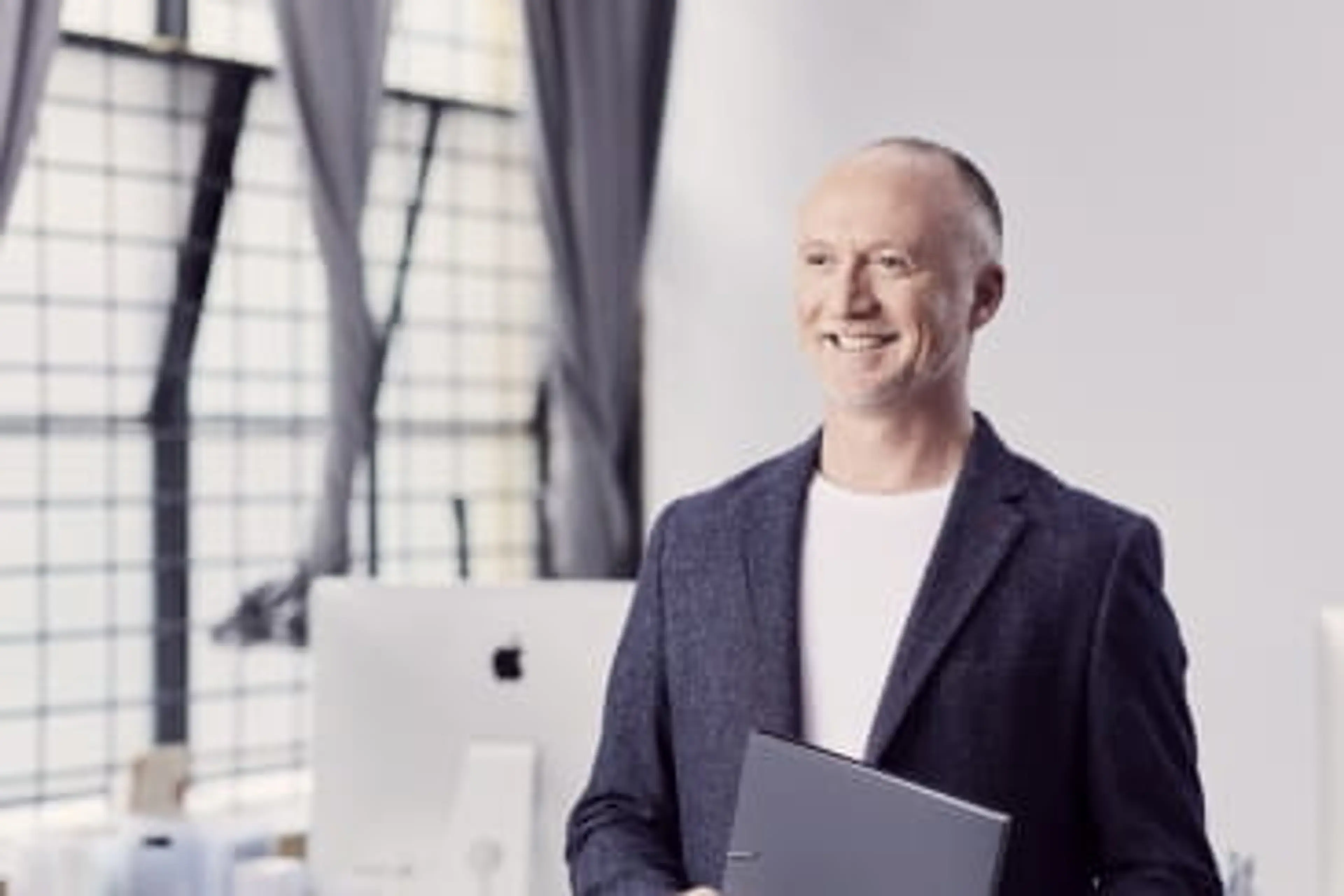 Open Universities Australia student David wearing professional clothes in a business setting.