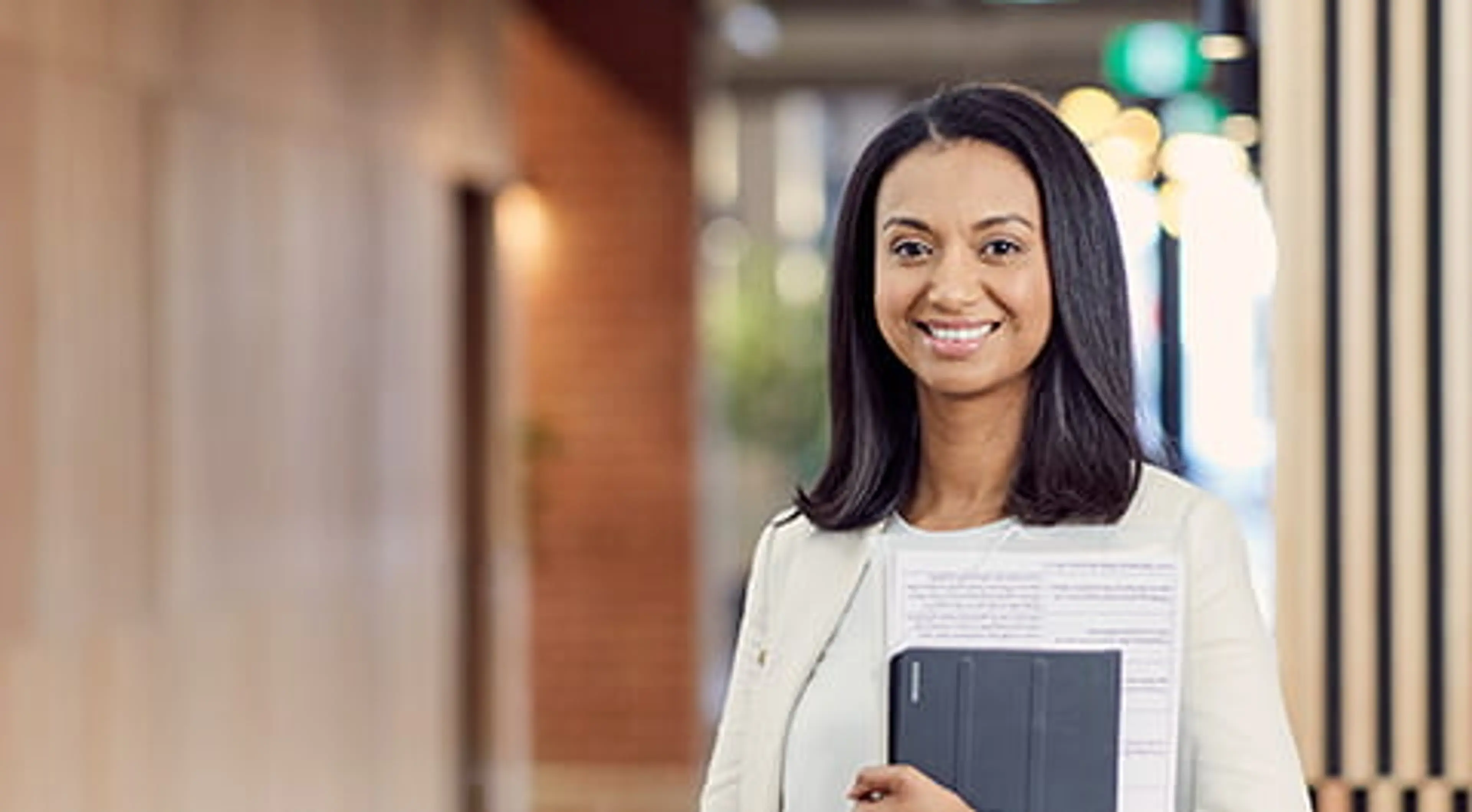 Open Universities Australia student Kelly wearing professional clothes in a business setting.