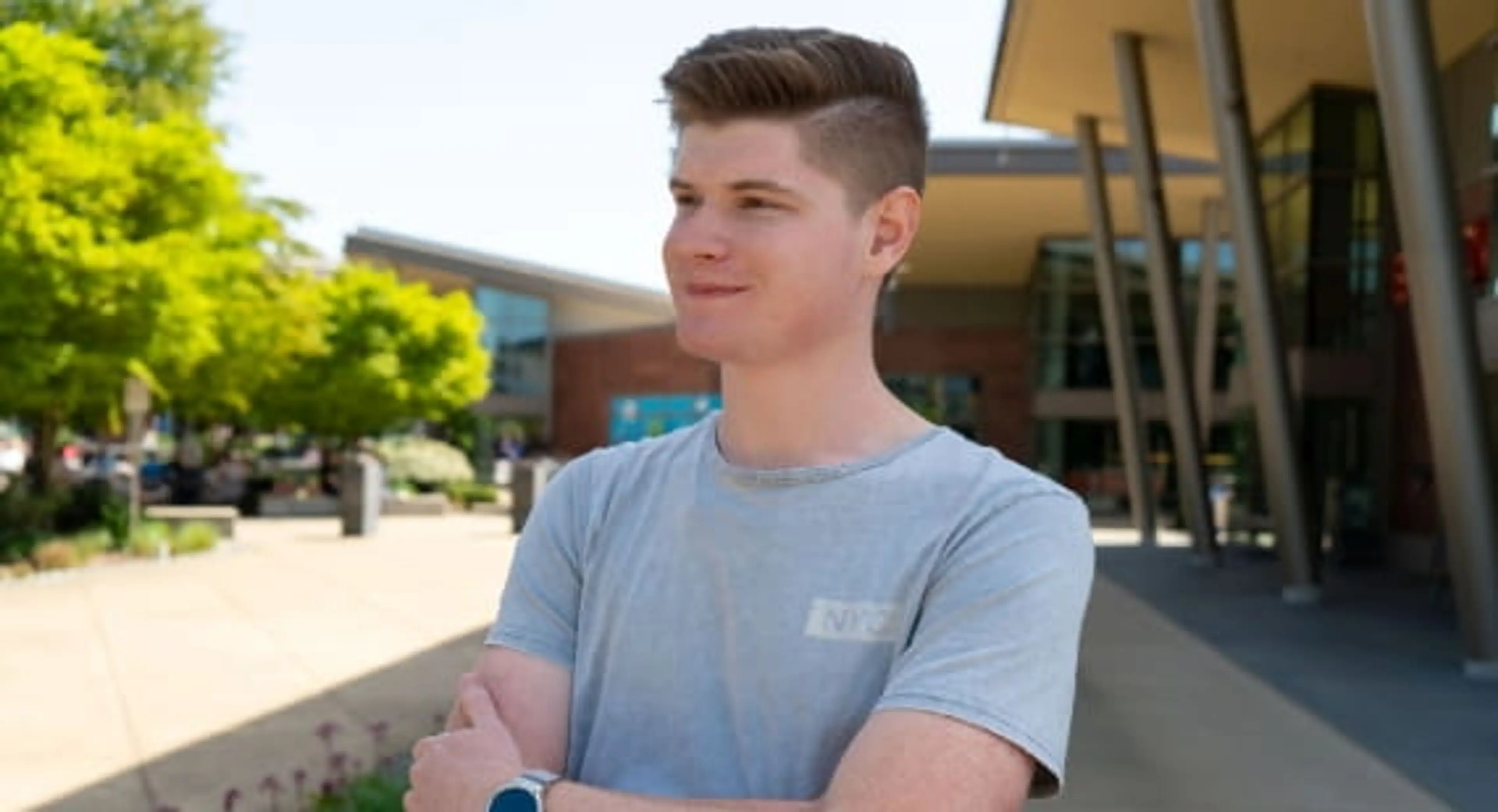 Open Universities Australia student, Ben, outside in front of a building.