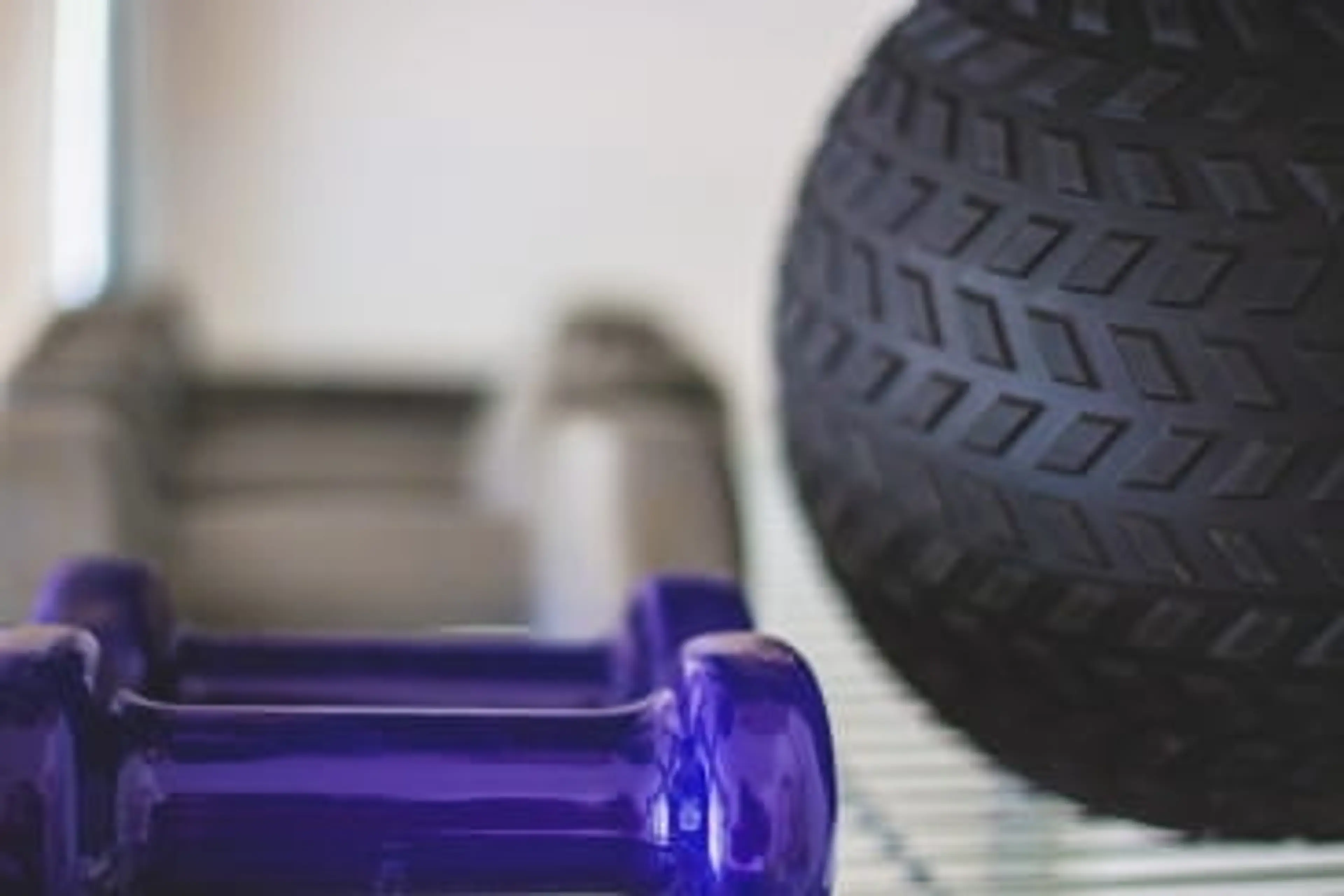 Exercise equipment including hand weights, dumbbells, and a textured massage ball 
