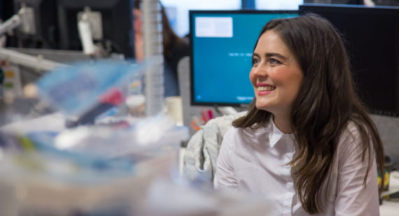 Open Universities Australia student, Nykkea, seated at a workstation.