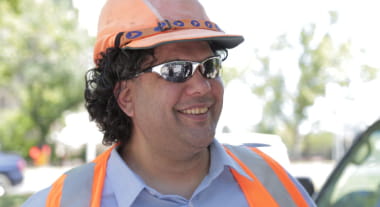 Open Universities Australia student, Conrad, wearing a hard hat and high visibility vest.